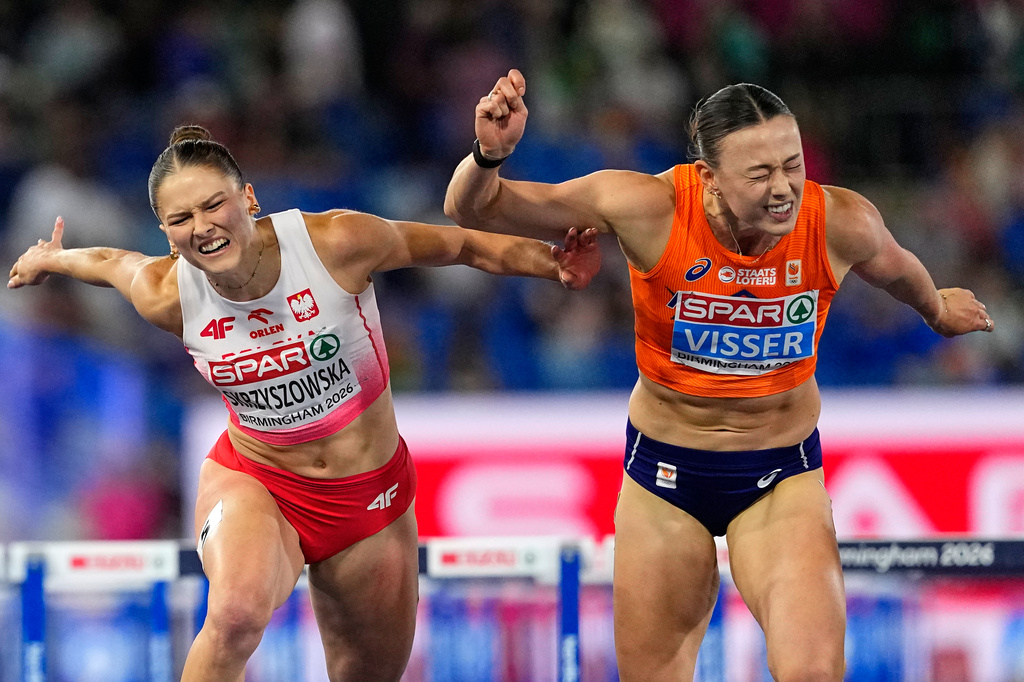 Netherlands' Nadine Visser crosses the line to win gold ahead of Poland's Pia Skrzyszowska, silver, in the women's 100 meters hurdles final at the European Athletics Championships in Birmingham, England, Tuesday, Aug. 11, 2026. (AP Photo/Petr David Josek)