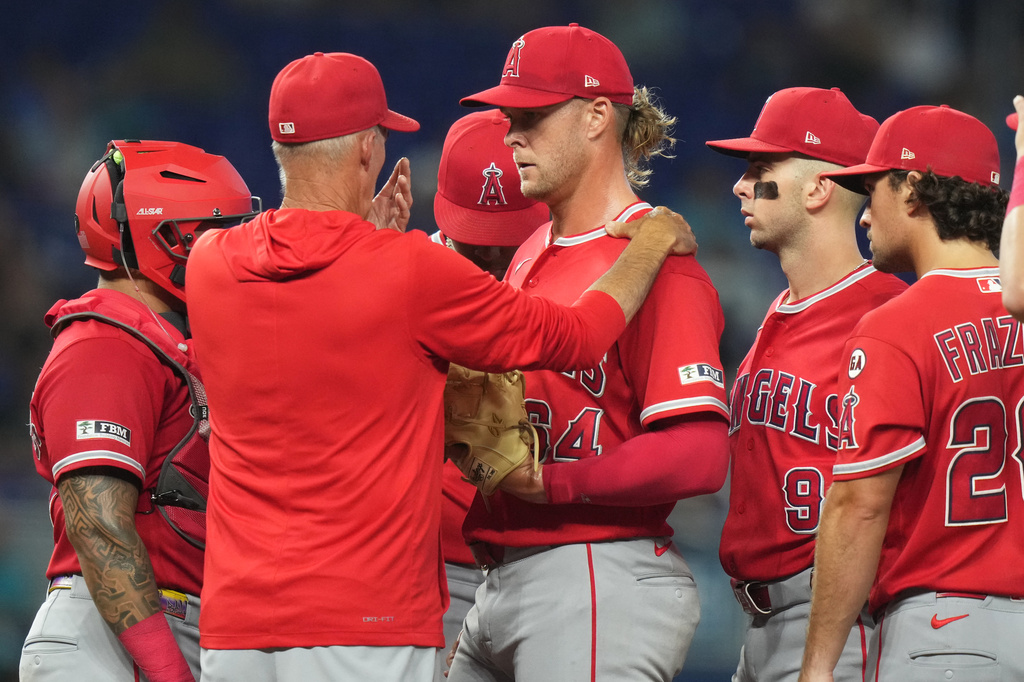 Los Angeles Angels pitching coach Mike Maddux, second from left, talks with relief pitcher Shaun Anderson, center, during the fifth inning of a baseball game against the Miami Marlins, Sunday, Aug. 9, 2026, in Miami. (AP Photo/Lynne Sladky)