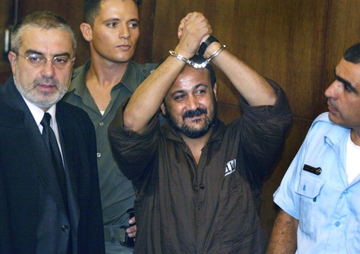 FILE - Marwan Barghouti, center, raises his handcuffed hands in the air on the opening day of his trial in Tel Aviv, Israel, Aug. 14, 2002. (AP Photo/Brennan Linsley, File) FILE - Marwan Barghouti, center, raises his handcuffed hands in the air on the opening day of his trial in Tel Aviv, Israel, Aug. 14, 2002. (AP Photo/Brennan Linsley, File)