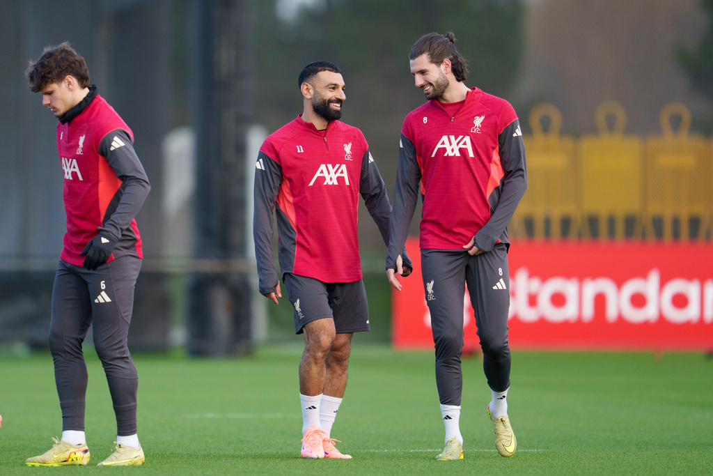 Liverpool's Mohamed Salah, centre left, speaks with teammate Dominik Szoboszlai as they take part in a training session in Liverpool, England, Monday, Dec. 8, 2025. (AP Photo/Jon Super)