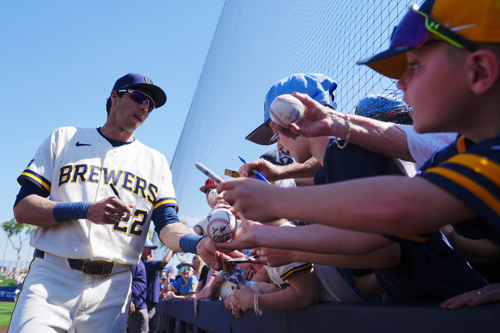 Milwaukee Brewers' Christian Yelich signs autographs prior to a spring training baseball game against the Los Angeles Dodgers Monday, March 9, 2026, in Phoenix. (AP Photo/Ross D. Franklin)