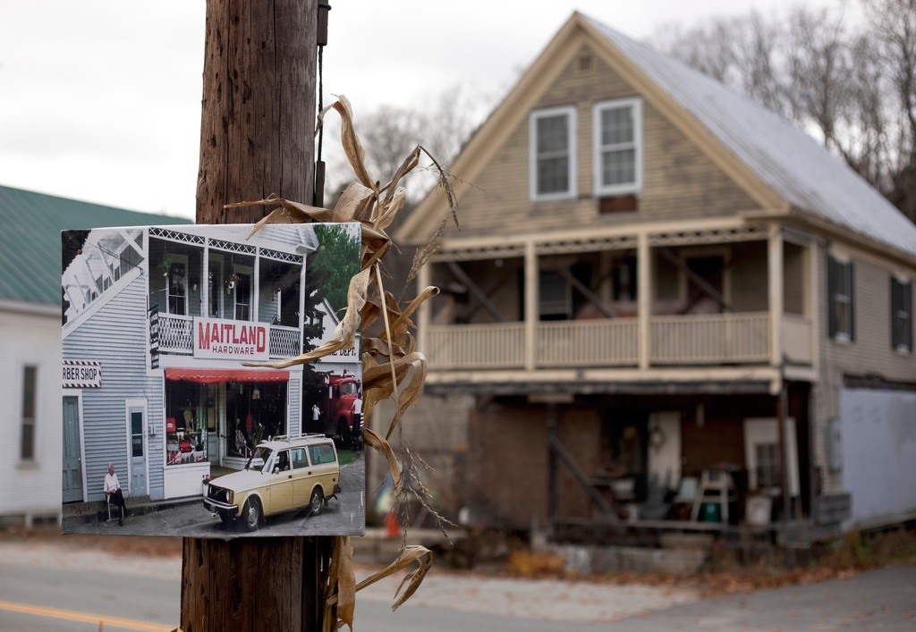 A photo of Maitland Hardware, the fictional hardware store featured in the first "Beetlejuice" film, hangs on a pole in front of the real hardware store used in the filming in East Corinth, Vt., Oct. 28, 2025. (AP Photo/Amanda Swinhart)