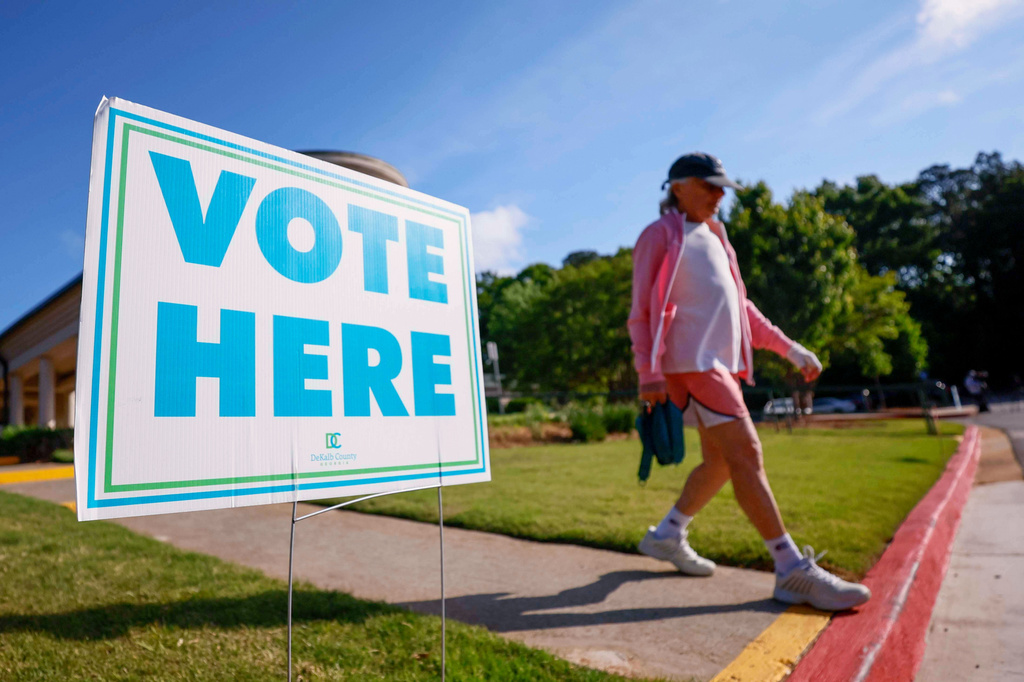 A person walks past a voting sign during the first day of early voting for the primary elections at the Dunwoody Library in Atlanta, Monday, April 27, 2026. (Miguel Martinez/Atlanta Journal-Constitution via AP)