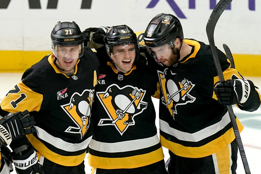 Pittsburgh Penguins' Ryan Shea (5) celebrates with Evgeni Malkin (71) and Justin Brazeau (16) after scoring during the first period of an NHL hockey game against the Columbus Blue Jackets, Saturday, Oct. 25, 2025, in Pittsburgh. (AP Photo/Matt Freed) Pittsburgh Penguins' Ryan Shea (5) celebrates with Evgeni Malkin (71) and Justin Brazeau (16) after scoring during the first period of an NHL hockey game against the Columbus Blue Jackets, Saturday, Oct. 25, 2025, in Pittsburgh. (AP Photo/Matt Freed)