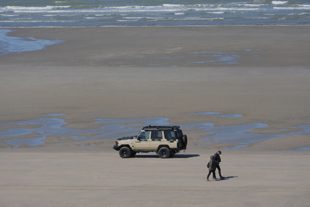 A French police car patrols on the beach of Zuydcoote, near Dunkirk, northern France, Thursday, April 23, 2026. (AP Photo/Michel Euler)
