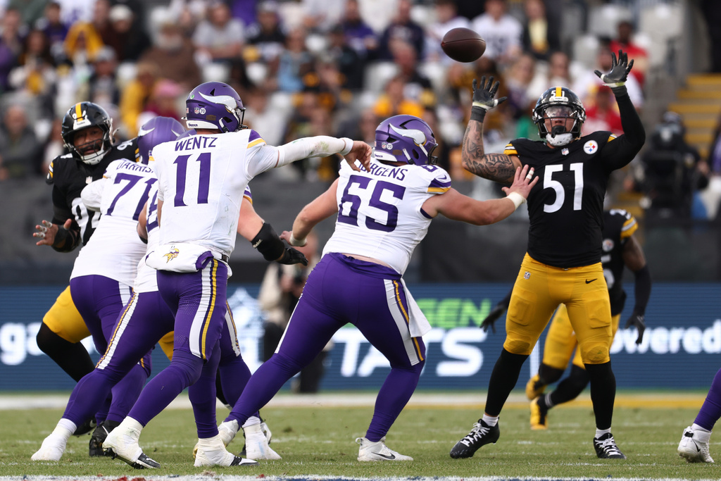Pittsburgh Steelers linebacker Nick Herbig (51) tries to catch a throw by Minnesota Vikings quarterback Carson Wentz (11) during the NFL football game between Minnesota Vikings and Pittsburgh Steelers at Croke Park stadium in Dublin, Sunday, Sept. 28, 2025.(AP Photo/Peter Morrison)