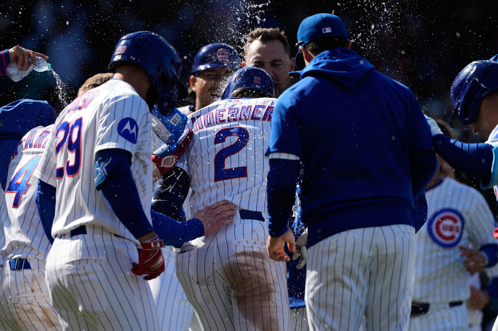 Chicago Cubs' Nico Hoerner (2) celebrates with teammates after hitting a sacrifice fly to New York Mets right fielder Tyrone Taylor during the 10th inning of a baseball game in Chicago, Sunday, April 19, 2026. (AP Photo/Nam Y. Huh)