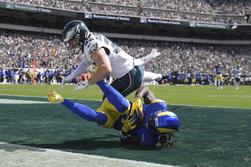 Los Angeles Rams wide receiver Davante Adams (17) catches a touchdown pass as Philadelphia Eagles safety Reed Blankenship (32) defends during the first half of an NFL football game Sunday, Sept. 21, 2025, in Philadelphia. (AP Photo/Matt Slocum)
