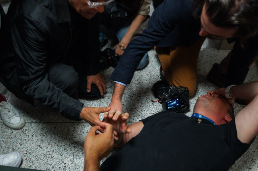 Bystanders assist journalist Vural Elibol as he lies on the floor after being shoved while covering detentions in immigration court on Tuesday, Sept., 30, 2025, in New York. (AP Photo/Olga Fedorova) Bystanders assist journalist Vural Elibol as he lies on the floor after being shoved while covering detentions in immigration court on Tuesday, Sept., 30, 2025, in New York. (AP Photo/Olga Fedorova)