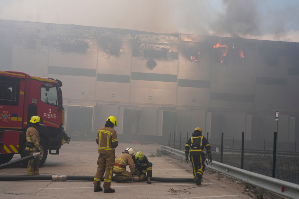 Firefighters put out a fire at warehouse stores after a Russian air attack in Kyiv, Ukraine, Thursday, Aug. 27, 2026. (AP Photo/Efrem Lukatsky)