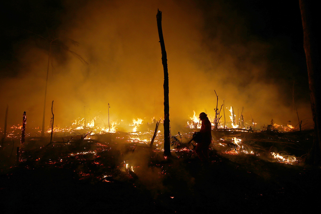 FILE - Firefighters work to put out a blaze in the Amazon forest during a drought and high temperatures in the rural municipality of Careiro Castanho, Amazonas state, Brazil, Oct. 21, 2023. (AP Photo/Edmar Barros, File)