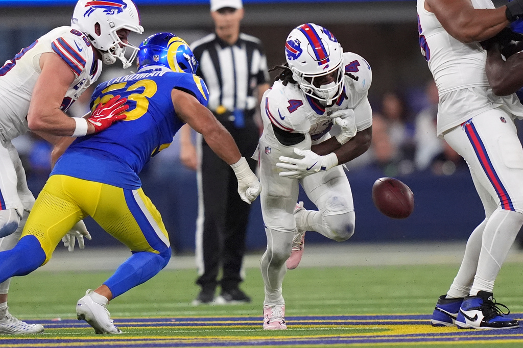 Buffalo Bills running back James Cook III, right, has the ball knocked out by Los Angeles Rams linebacker Nate Landman during the second half of an NFL football game, Monday, Oct. 12, 2026, in Inglewood, Calif. (AP Photo/Scott Strazzante)