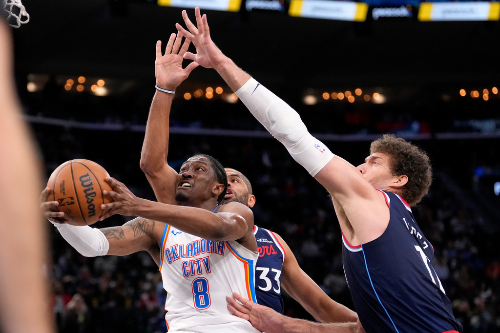 Oklahoma City Thunder guard Jalen Williams, left, shoots as Los Angeles Clippers forward Nicolas Batum, center, center Brook Lopez defend during the first half of an NBA basketball game Wednesday, April 8, 2026, in Inglewood, Calif. (AP Photo/Mark J. Terrill)