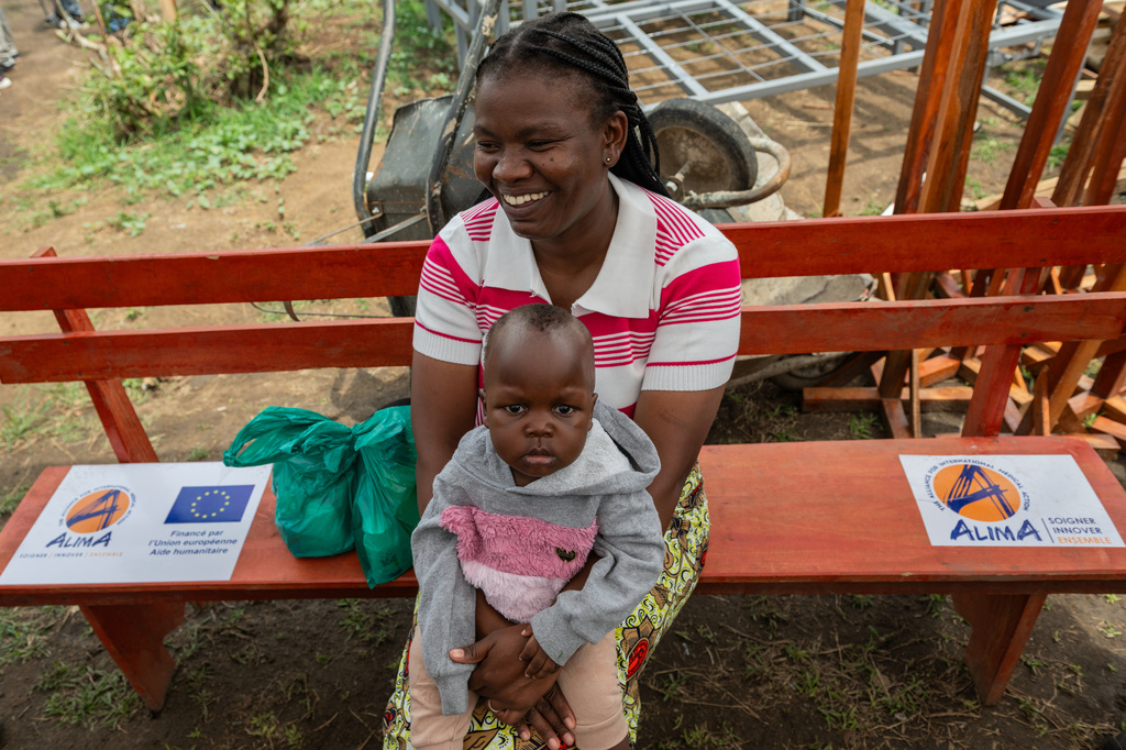 Kahindo Mireille Pierrette, an Ebola survivor, poses with her 16-month old baby, after they were declared to have survived Ebola and discharged from the Rwampara treatment Center in Ituri Congo, Tuesday, June 16, 2026. (AP Photo/Moses Sawasawa)