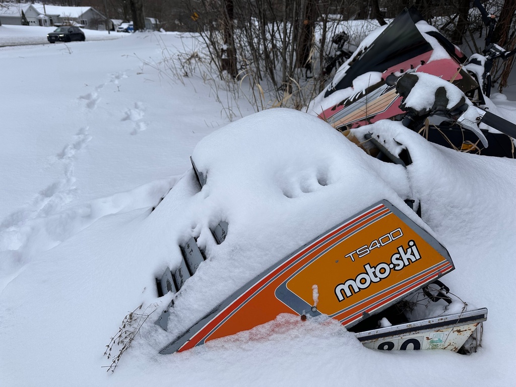 Fresh snow covers old snowmobiles on display in Lowville, N.Y,, on Saturday, Dec. 27, 2025. (AP Photo/Cara Anna)