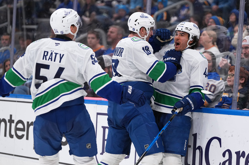 Vancouver Canucks' Kiefer Sherwood, right, is congratulated by Drew O'Connor (18) and Aatu Raty (54) after scoring a hat trick during the third period of an NHL hockey game against the St. Louis Blues Thursday, Oct. 30, 2025, in St. Louis. (AP Photo/Jeff Roberson) Vancouver Canucks' Kiefer Sherwood, right, is congratulated by Drew O'Connor (18) and Aatu Raty (54) after scoring a hat trick during the third period of an NHL hockey game against the St. Louis Blues Thursday, Oct. 30, 2025, in St. Louis. (AP Photo/Jeff Roberson)
