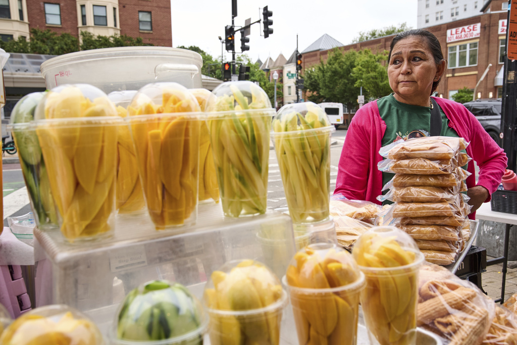 Gloria Gomez, 58, of Washington, tends her fruit stand, Tuesday, Aug. 19, 2025, as she waits for customers in the Columbia Heights neighborhood of northwest Washington. "Business is worse now than it was during the pandemic," says Gomez, "over the last three weeks it's been less and less." (AP Photo/Jacquelyn Martin)