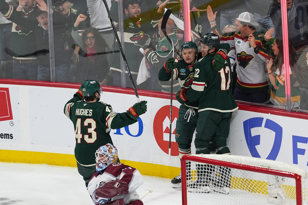 Minnesota Wild left wing Kirill Kaprizov, second from right, celebrates with defenseman Quinn Hughes (43) and left wing Matt Boldy (12) after scoring during the first period of Game 3 of an NHL Stanley Cup hockey second-round playoff series against the Colorado Avalanche, Saturday, May 9, 2026, in St. Paul, Minn. (AP Photo/Abbie Parr)