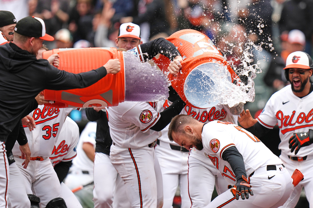 Baltimore Orioles' Colton Cowser (17) celebrates with teammates after hitting a walkoff three-run home run during the ninth inning in the first baseball game of a doubleheader against the Detroit Tigers, Sunday, May 24, 2026, in Baltimore. (AP Photo/Stephanie Scarbrough)
