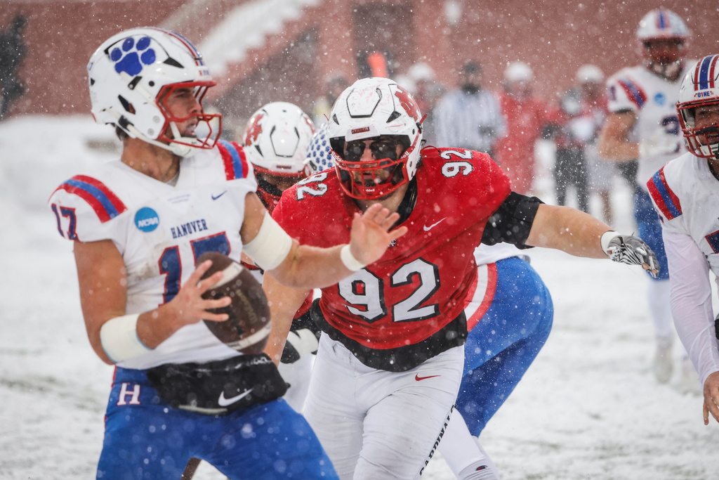 In this image provided by North Central College Athletics, North Central defensive lineman John Sullivan (92) rushes Hanover quarterback Eian Roudebush during a Div. III NCAA college football game, Nov. 29, 2025, in Naperville, Ill. (Steve Woltmann/ North Central Athletics via AP)