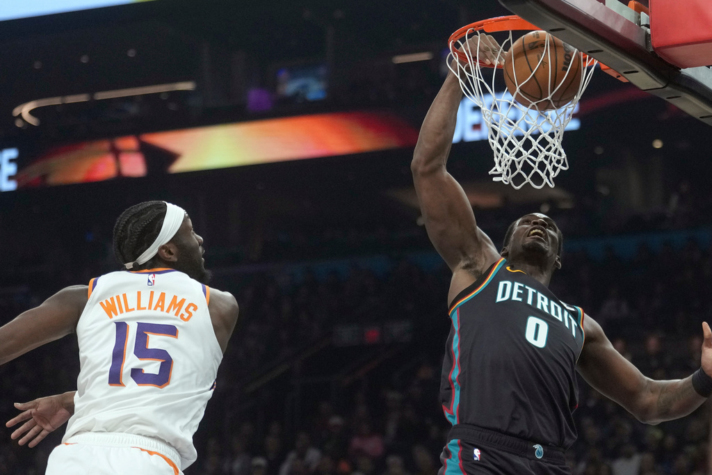 Detroit Pistons center Jalen Duren (0) dunks against Phoenix Suns center Mark Williams (15) during the first half of an NBA basketball game Thursday, Jan. 29, 2026, in Phoenix. (AP Photo/Ross D. Franklin)