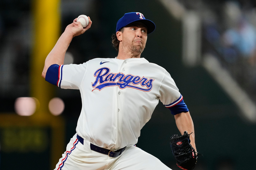 Texas Rangers pitcher Jacob Degrom throws to the Houston Astros in the first inning of a baseball game Wednesday, May 27, 2026, in Arlington, Texas. (AP Photo/Tony Gutierrez)