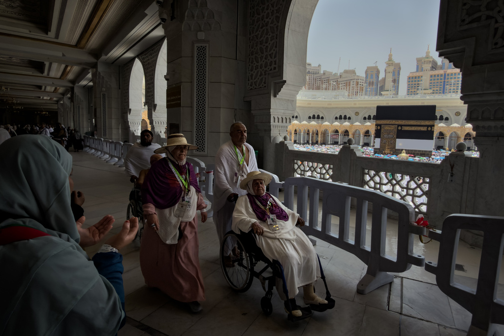 A Muslim pilgrim on a wheelchair circumambulates the Kaaba, the cubic building at the Grand Mosque, during the annual Hajj pilgrimage, in Mecca, Saudi Arabia, Thursday, May 21, 2026. (AP Photo/Altaf Qadri)