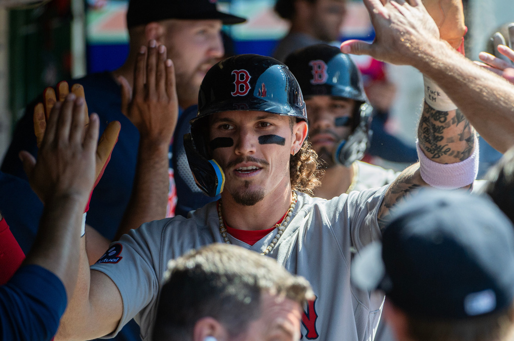 Boston Red Sox's Jarren Duran is greeted by teammates after scoring on an RBI single by Masataka Yoshida during the seventh inning of a baseball game against the Cleveland Guardians, Sunday, May 31, 2026, in Cleveland. (AP Photo/Phil Long)