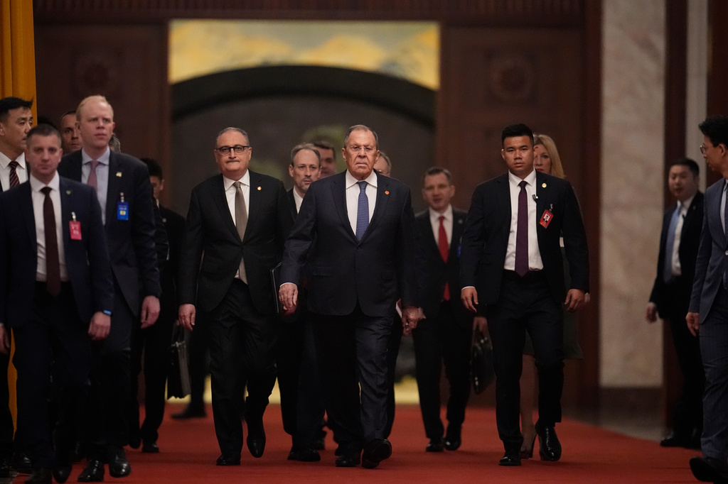 Russia's Foreign Minister Sergey Lavrov, center, walks for a meeting with China's President Xi Jinping, at the Great Hall of the People in Beijing, China Wednesday, April 15, 2026. (Iori Sagisawa/Pool Photo via AP)