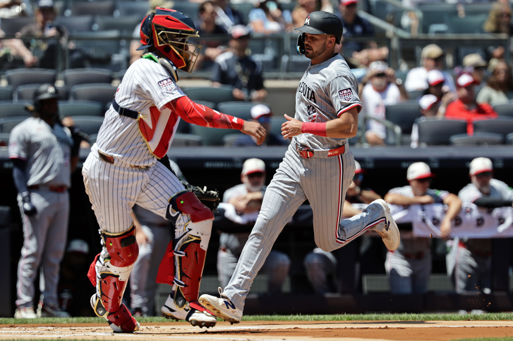 Minnesota Twins' Trevor Larnach (9) scores a run past New York Yankees catcher Ali Sánchez during the first inning of a baseball game Saturday, July 4, 2026, in New York. (AP Photo/Adam Hunger)