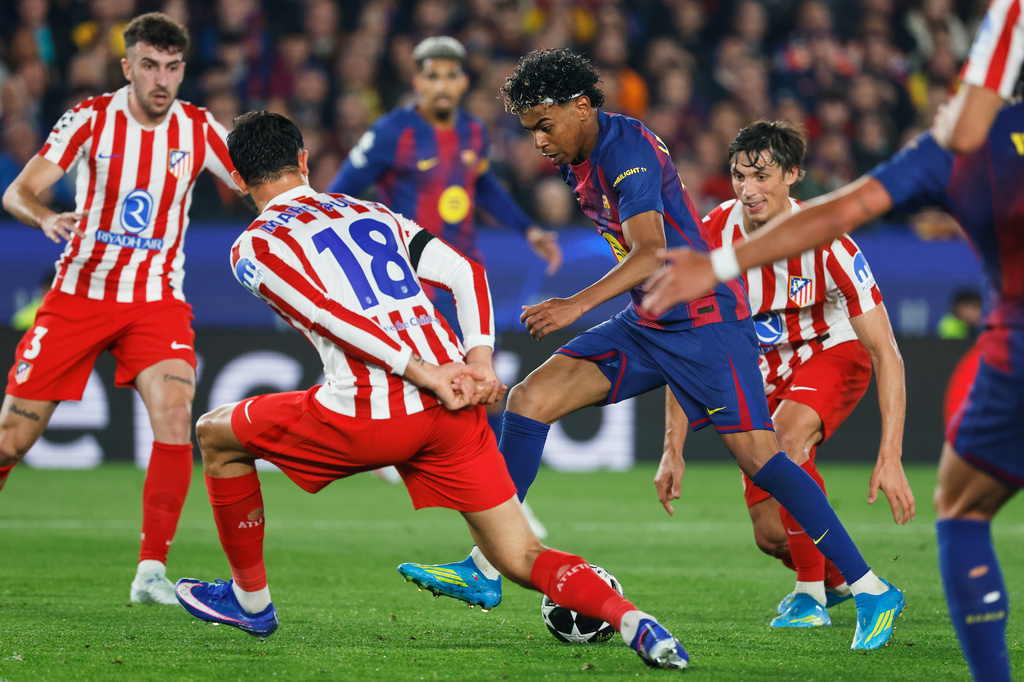 Barcelona's Lamine Yamal challenges for the ball with Atletico Madrid's Marc Pubill during the Champions League quarterfinal first leg soccer match between Barcelona and Atletico Madrid in Barcelona, Spain, Wednesday, April 8, 2026. (AP Photo/Joan Monfort)
