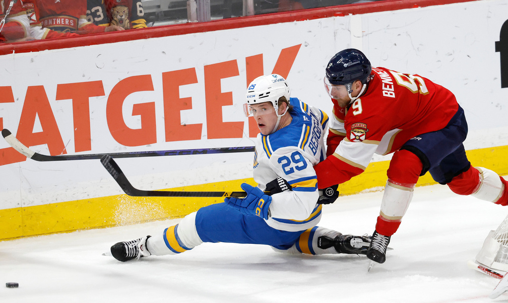 St. Louis Blues right wing Jonatan Berggren (29) and Florida Panthers center Sam Bennett (9) chase the puck during the second period of an NHL hockey game, Saturday, Dec. 20, 2025, in Sunrise, Fla. (AP Photo/Rhona Wise)