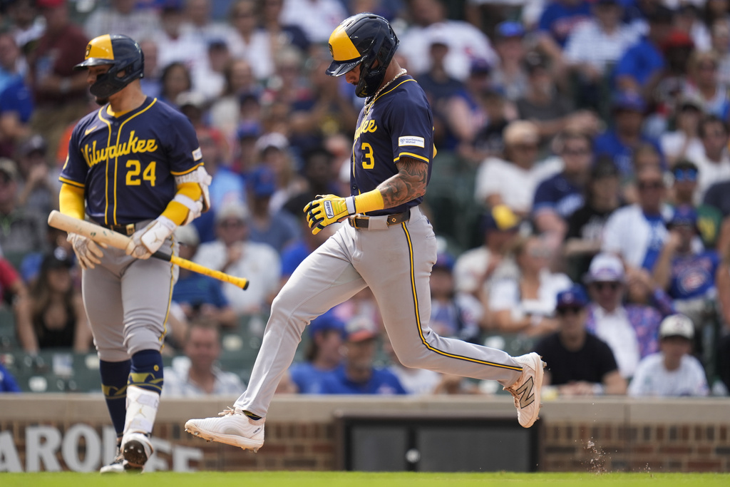 Milwaukee Brewers' Joey Ortiz (3) scores a wild pitch from Chicago Cubs pitcher Gavin Hollowell (not shown) during the eighth inning of the first baseball game of a split doubleheader Monday, Aug. 18, 2025, in Chicago. (AP Photo/Erin Hooley)