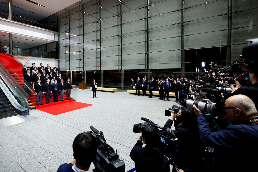 Japan's Prime Minister Sanae Takaichi, front row center, poses with her new cabinet members at the prime minister's office in Tokyo, on Tuesday, Oct. 21, 2025. (Kiyoshi Ota/Pool via AP)