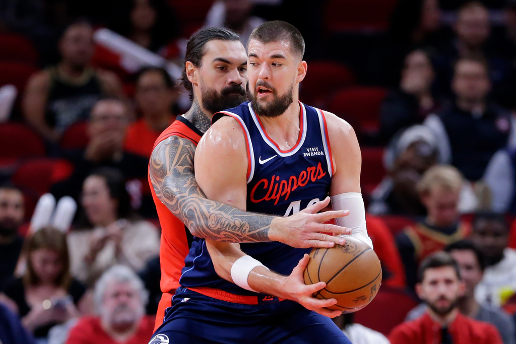 Houston Rockets center Steven Adams, left, reaches in as LA Clippers center Ivica Zubac, right, looks to drive around him during the first half of an NBA basketball game Thursday, Dec. 11, 2025, in Houston. (AP Photo/Michael Wyke)