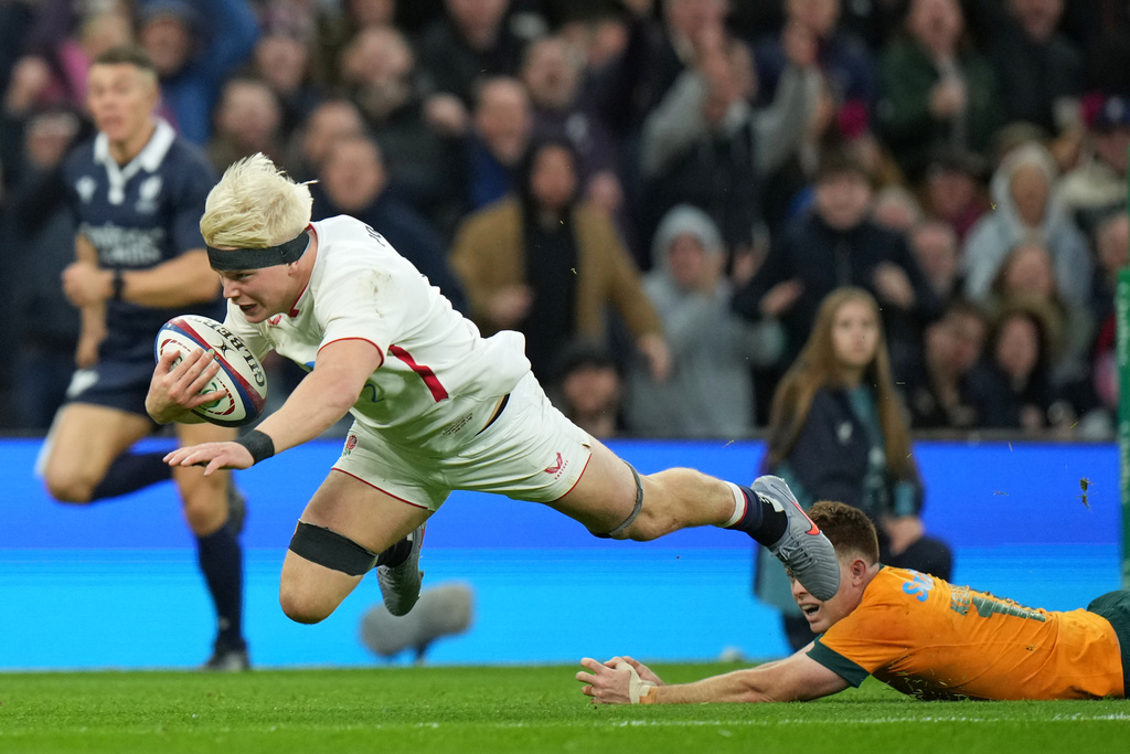 England's Henry Pollock dives over to score a try during the rugby union Nations Series match between England and Australia in Twickenham, London, Saturday, Nov. 1, 2025. (AP Photo/Alastair Grant)