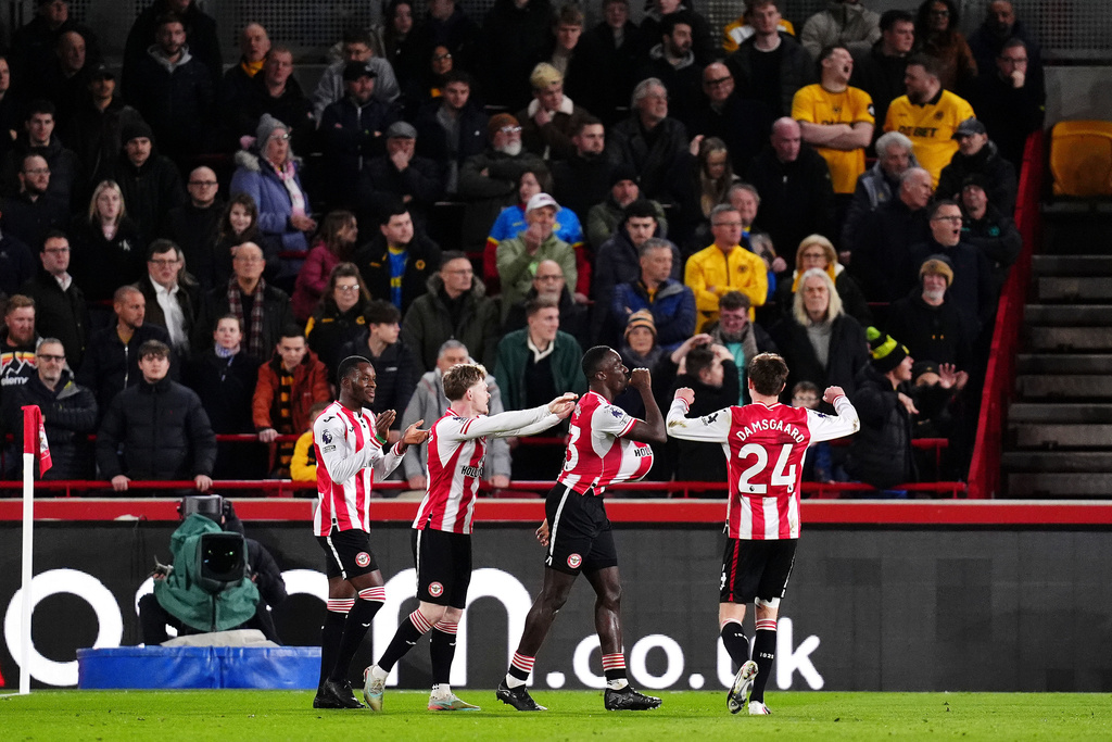 Brentford's Michael Kayode, second right, celebrates scoring with teammates during the English Premier League soccer match between Brentford and Wolverhampton Wanderers in London, Monday March 16, 2026. (John Walton/PA via AP)