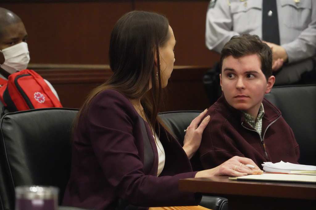 Defense attorney Kellie Mannette touches Austin Thompson's shoulder during a hearing in Wake County Superior Court on Wednesday, Jan. 21, 2026, in Raleigh, N.C. (AP Photo/Allen G. Breed)