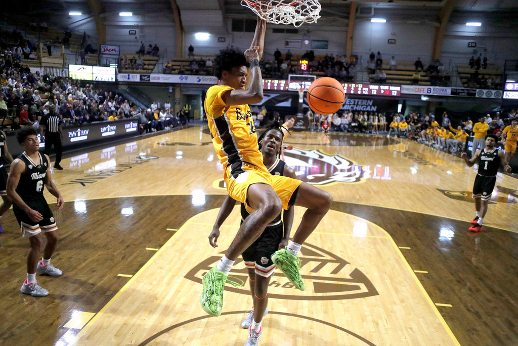 Western Michigan guard Jayden Brewer, center eft, dunks against Miami (Ohio) forward Antwone Woolfolk, center right, during the first half of an NCAA college basketball game, Friday, Feb. 27, 2026, in Kalamazoo, Mich. (AP Photo/Al Goldis)
