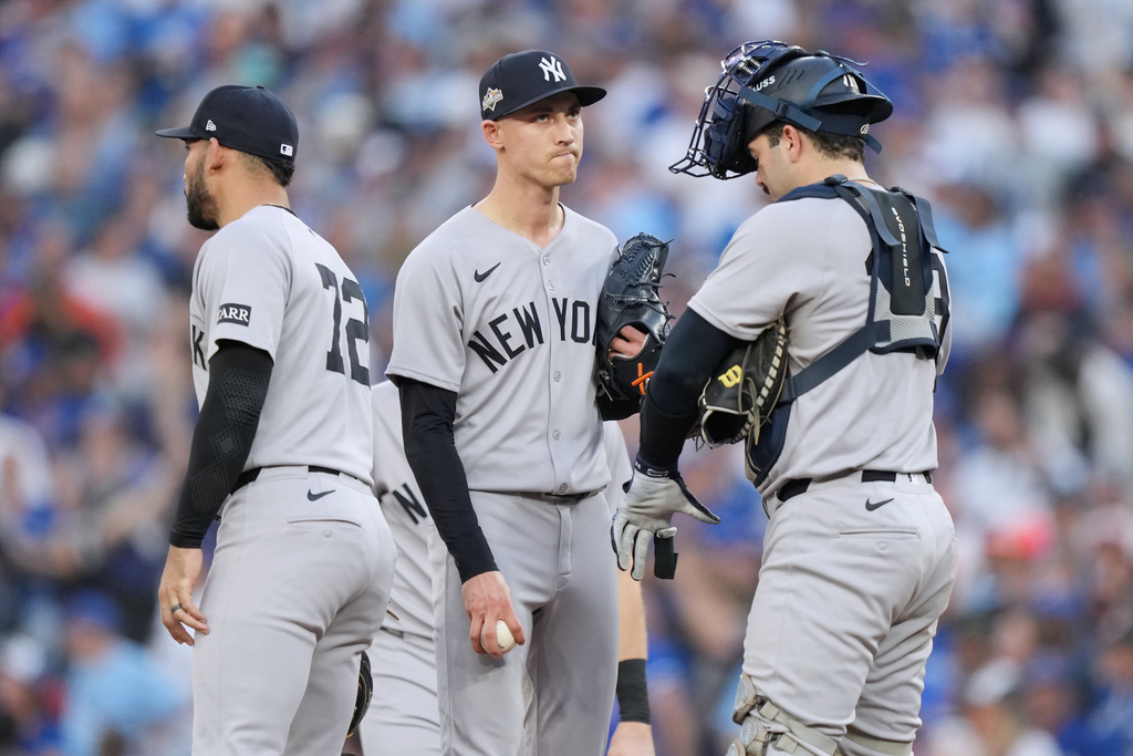 New York Yankees pitcher Luke Weaver, center, waits to be removed during the seventh inning against the Toronto Blue Jays in Game 1 of baseball's American League Division Series, Saturday, Oct. 4, 2025, in Toronto. (Nathan Denette/The Canadian Press via AP)