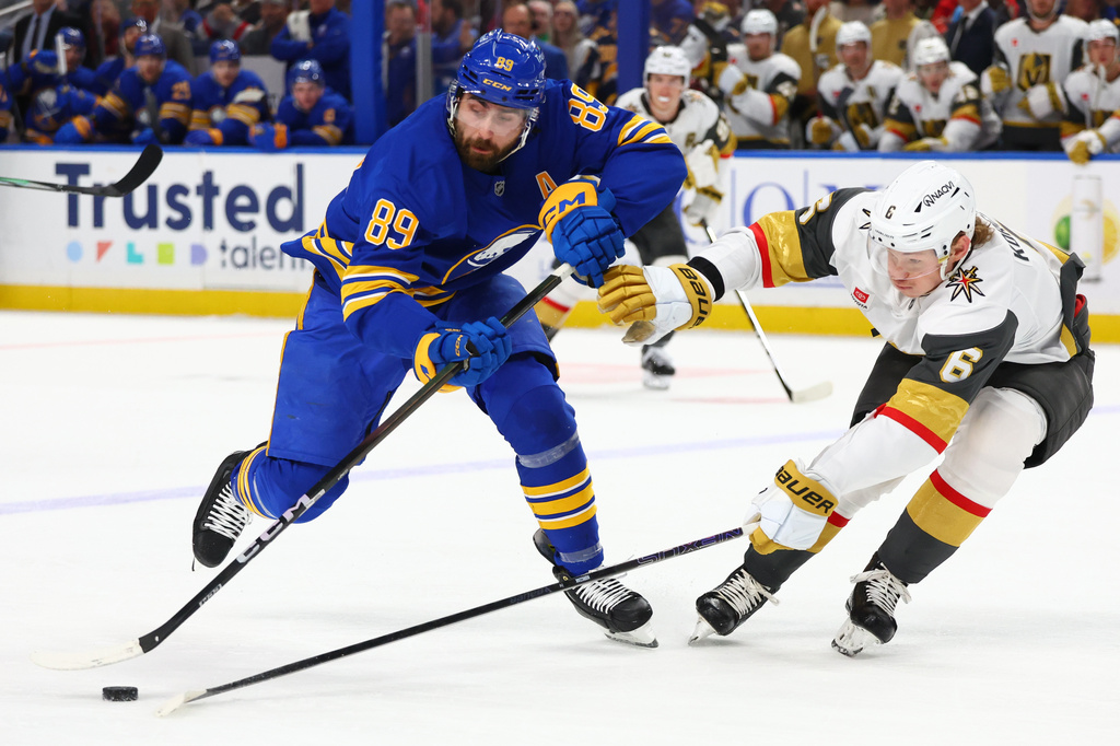 FILE - Buffalo Sabres right wing Alex Tuch (89) is stick checked by Vegas Golden Knights defenseman Kaedan Korczak (6) during the first period of an NHL hockey game, March 3, 2026, in Buffalo, N.Y. (AP Photo/Jeffrey T. Barnes, File)