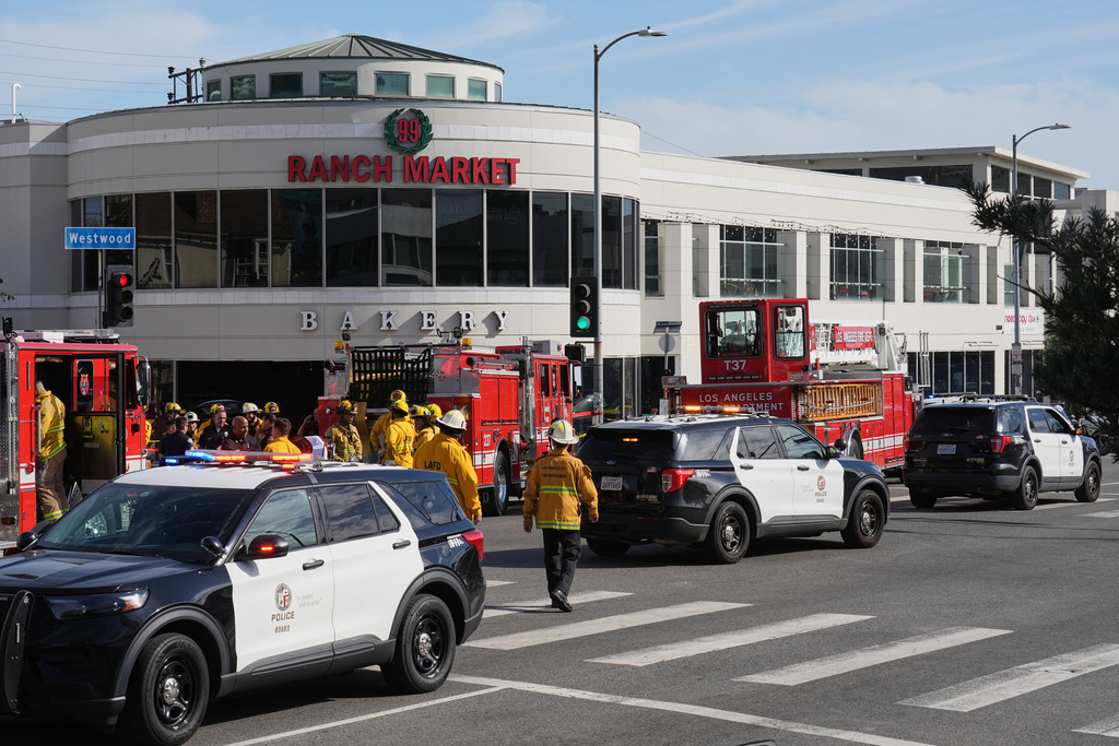 First responders work the scene of a fatal crash outside of a 99 Ranch Market, Thursday, Feb. 5, 2026, in the Westwood neighborhood of Los Angeles.(AP Photo/Damian Dovarganes)