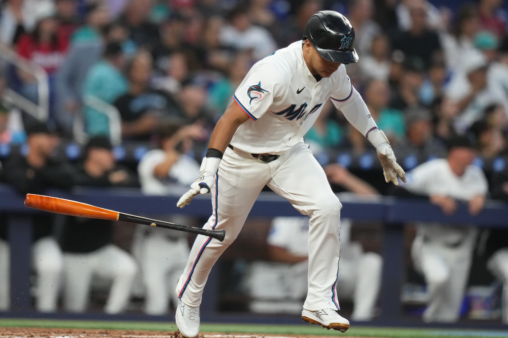 Miami Marlins' Javier Sanoja drops his bat after hitting a RBI single to score Owen Caissie during the second inning of a baseball game against the Colorado Rockies, Friday, March 27, 2026, in Miami. (AP Photo/Lynne Sladky)