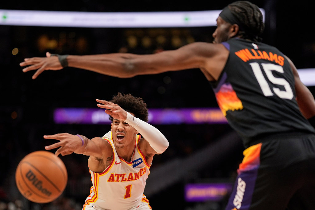 Atlanta Hawks forward Jalen Johnson (1) passes against Phoenix Suns center Mark Williams (15) during the first half of an NBA basketball game, Friday, Jan. 23, 2026, in Atlanta. (AP Photo/Mike Stewart)