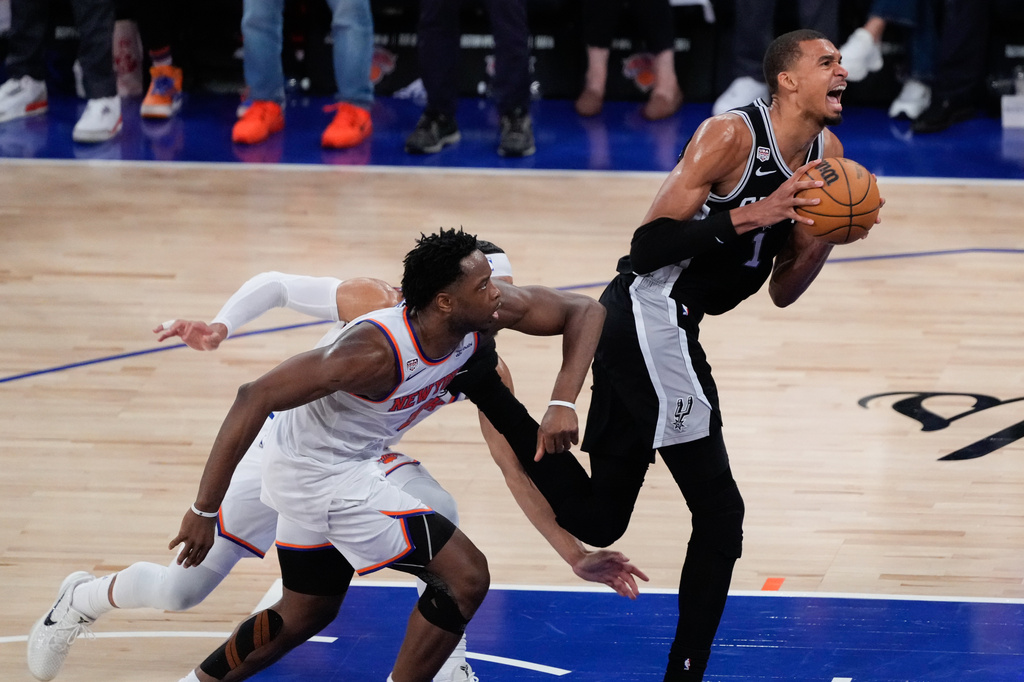San Antonio Spurs forward Victor Wembanyama, right, drives as New York Knicks forward Og Anunoby, left, defends during the second half of Game 4 of the NBA Finals basketball series, Wednesday, June 10, 2026, in New York. (AP Photo/Ross D. Franklin)