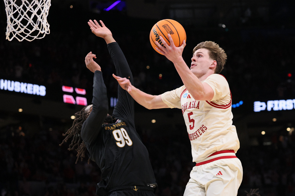 Nebraska forward Braden Frager (5) goes to the basket for the winning shot against Vanderbilt forward Devin McGlockton (99) during the second half in the second round of the NCAA college basketball tournament, Saturday, March 21, 2026, in Oklahoma City. (AP Photo/Nate Billings)