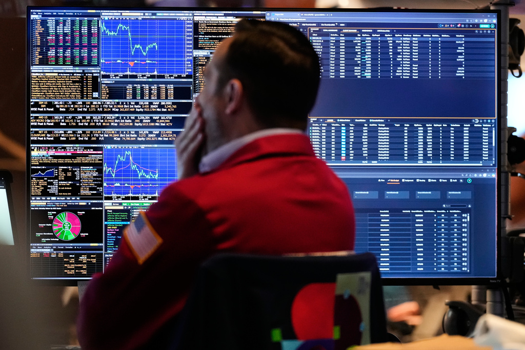 A trader looks at financial information on his computer on the floor at the New York Stock Exchange in New York, Wednesday, Oct. 1, 2025. (AP Photo/Seth Wenig)
