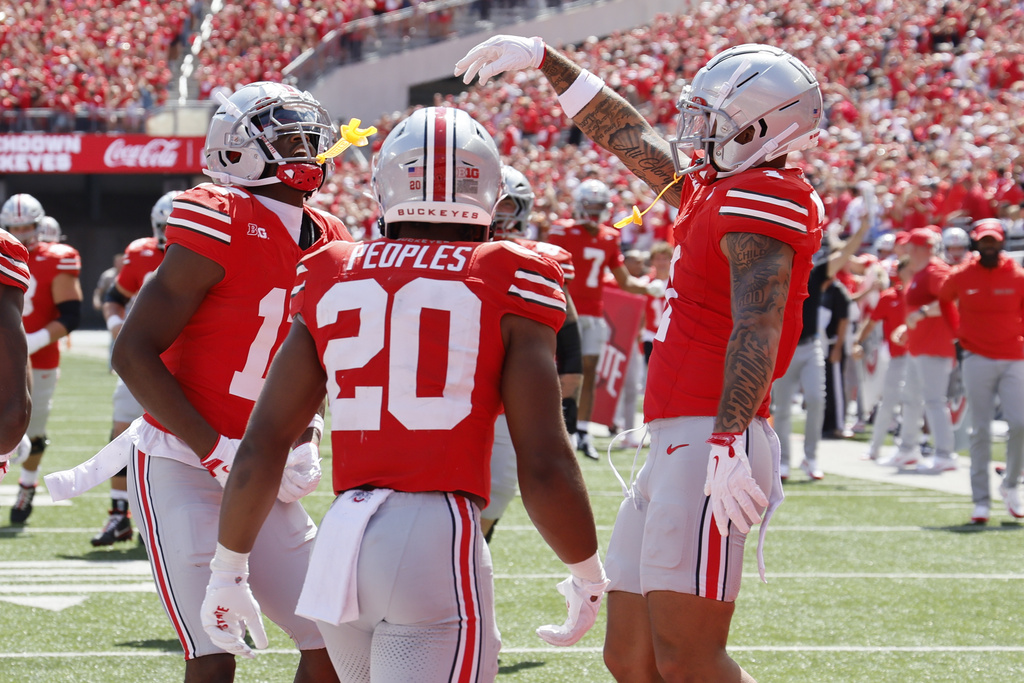 Ohio State receiver Carnell Tate, left, celebrates his touchdown against Texas during the second half of an NCAA college football game, Saturday, Aug. 30, 2025, in Columbus, Ohio. (AP Photo/Jay LaPrete)