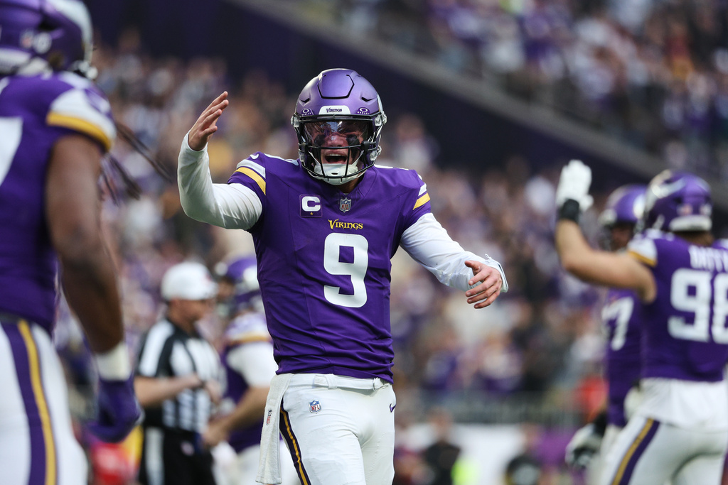 Minnesota Vikings quarterback J.J. McCarthy (9) reacts after running back Jordan Mason, foreground left, scored a touchdown during the first half of an NFL football game against the Washington Commanders, Sunday, Dec. 7, 2025, in Minneapolis. (AP Photo/Matt Krohn)