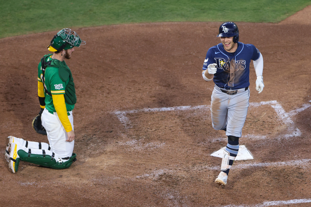 Tampa Bay Rays' Taylor Walls, right, reacts after touching home plate on a solo home run during the sixth inning of a baseball game against the Athletics Tuesday, Aug. 11, 2026, in West Sacramento, Calif. (AP Photo/Scott Marshall)